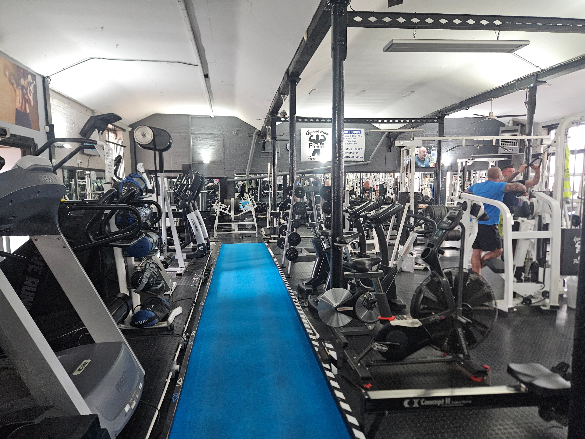 Cardio aisle with treadmills, bikes and rowers